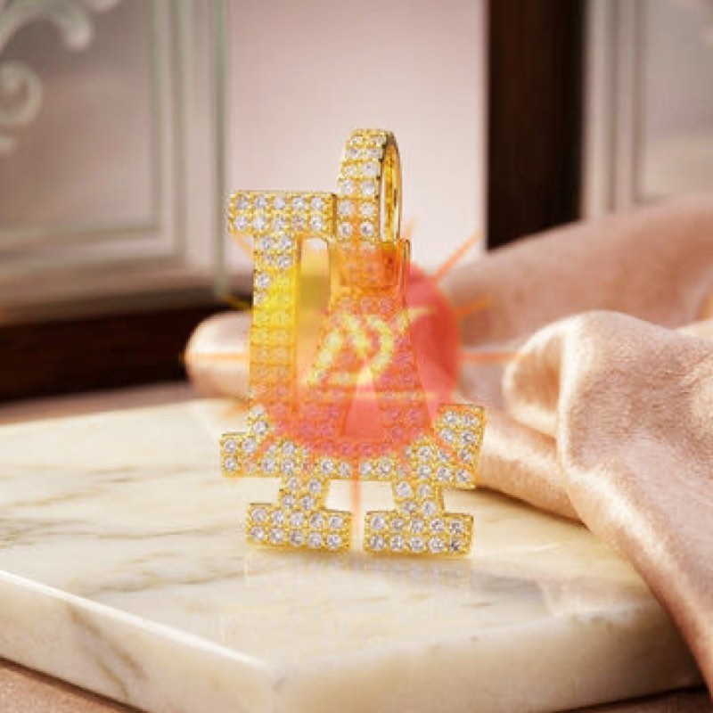 A gold initial pendant pavé-set with clear stones
