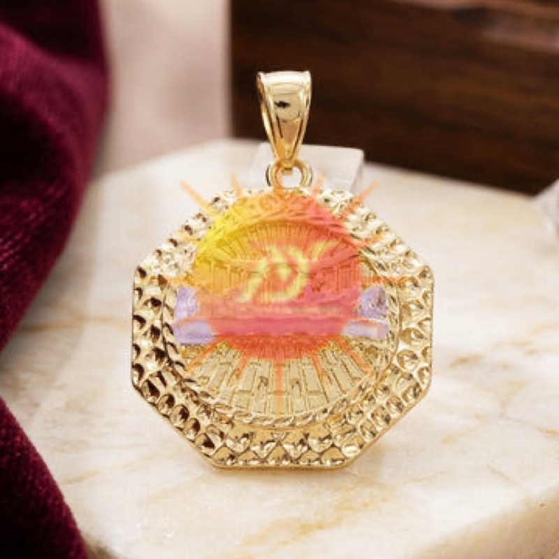 An octagonal gold pendant with a textured border
